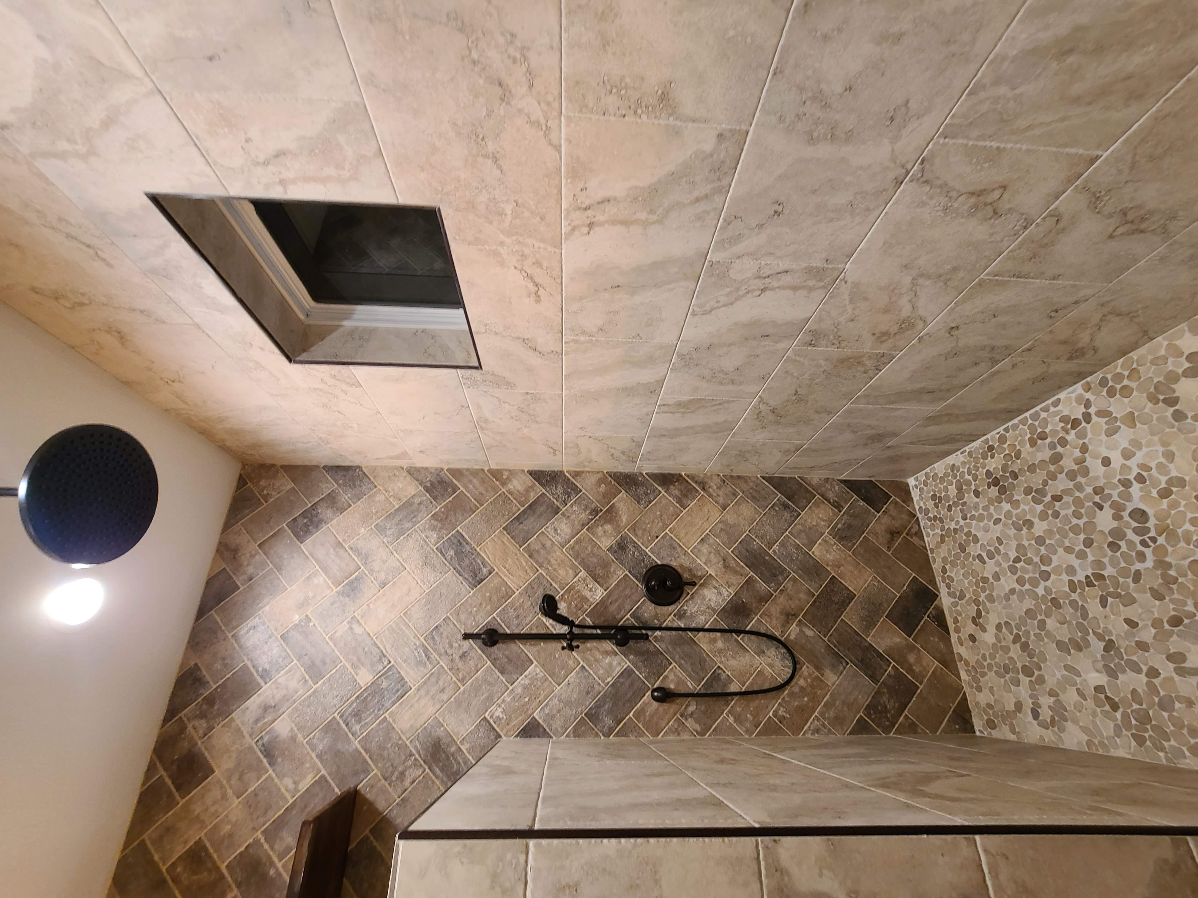 Herringbone pebble master shower