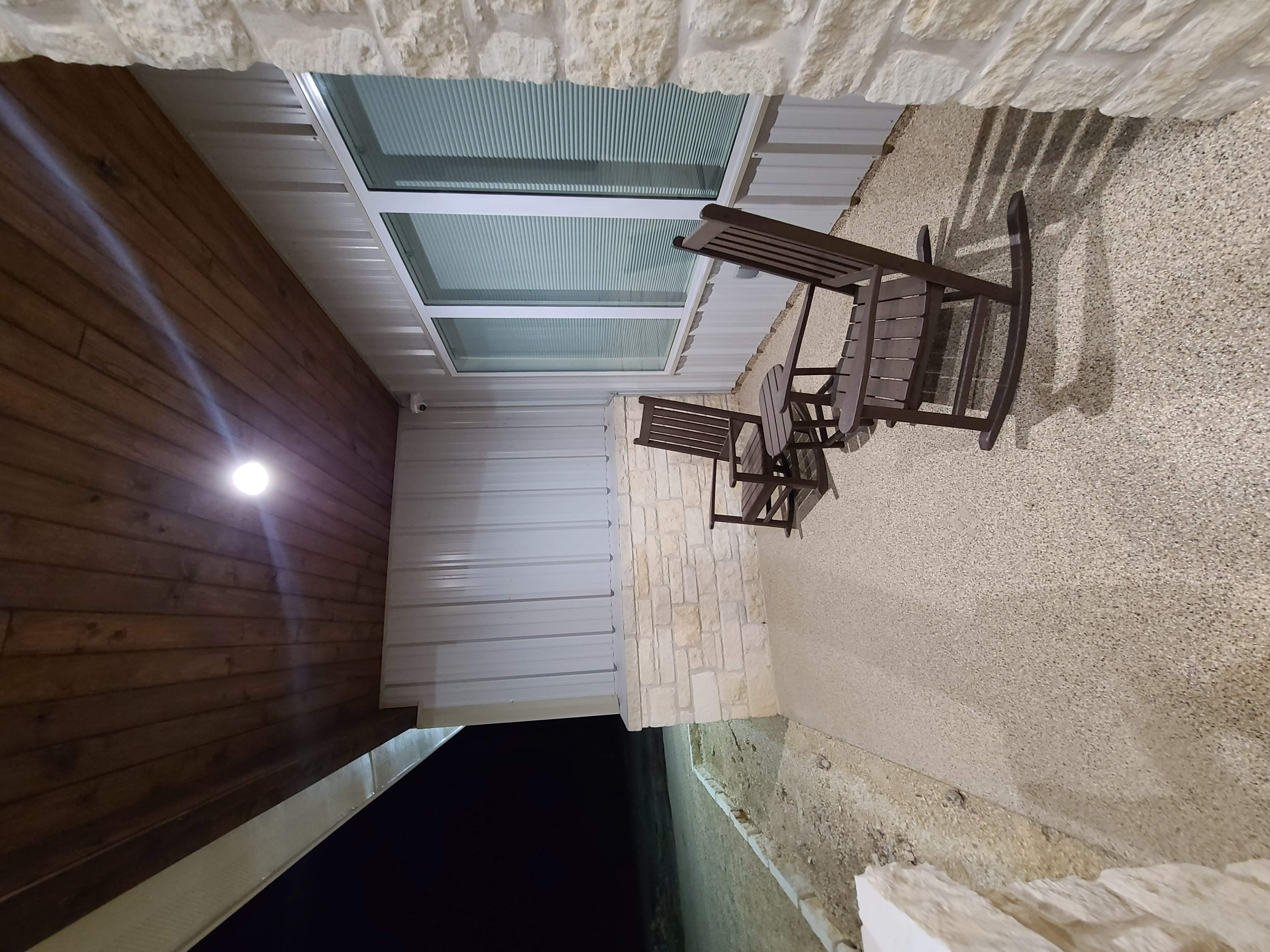 Covered porch stone wood ceiling